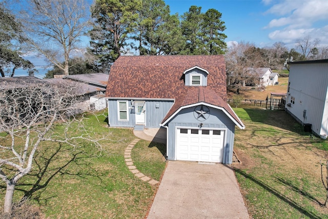 view of front of property featuring an outbuilding, a garage, and a front lawn