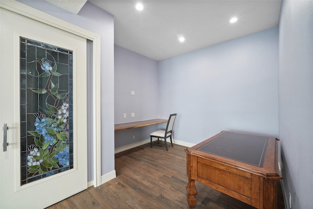 office space with built in desk and dark hardwood / wood-style floors