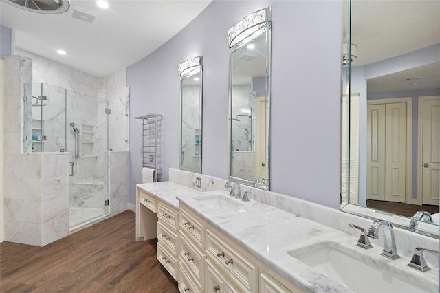 bathroom featuring wood-type flooring, vanity, and walk in shower