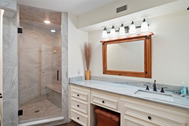 bathroom featuring vanity and a shower with shower door