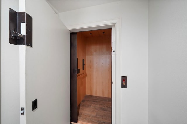 hall with elevator and hardwood / wood-style floors