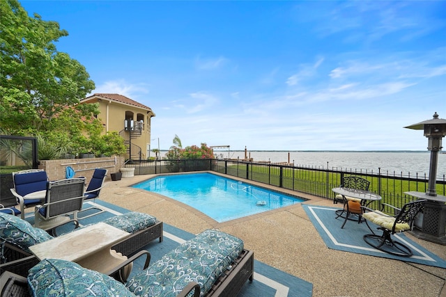 view of swimming pool with a water view and a patio area