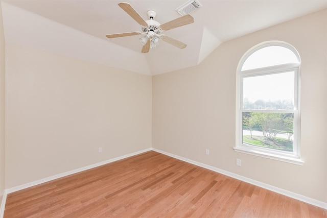 unfurnished room with lofted ceiling, ceiling fan, and light wood-type flooring