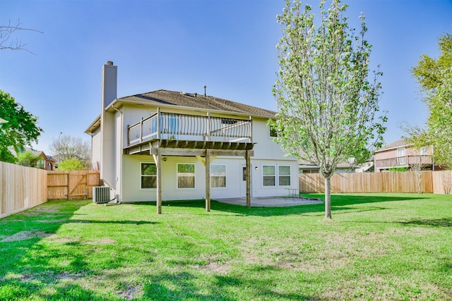 back of property featuring a yard, a patio area, and central air condition unit