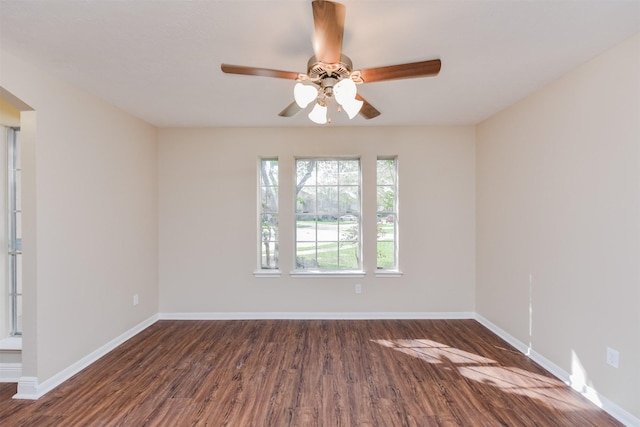 unfurnished room featuring dark wood-type flooring and ceiling fan