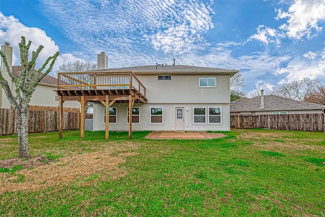 back of house with a yard and a patio