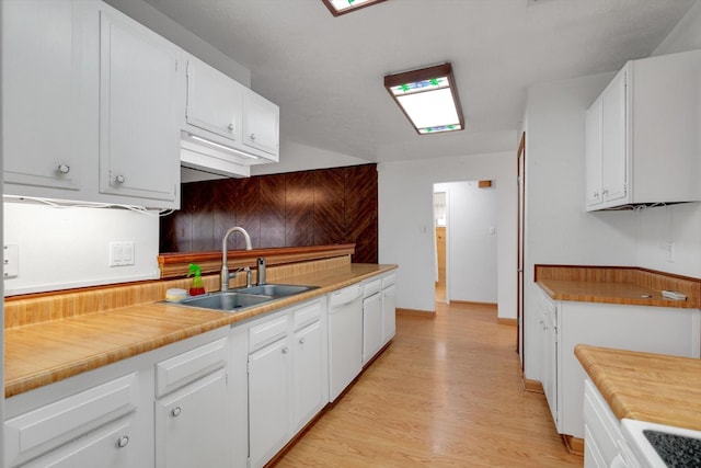 kitchen featuring white cabinetry, dishwasher, sink, and light wood-type flooring