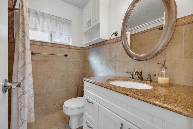 bathroom featuring vanity, toilet, and tile walls