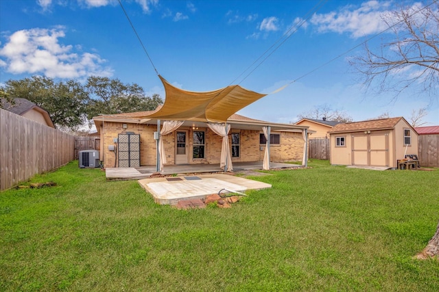 back of property featuring a lawn, a patio area, a shed, and central air condition unit