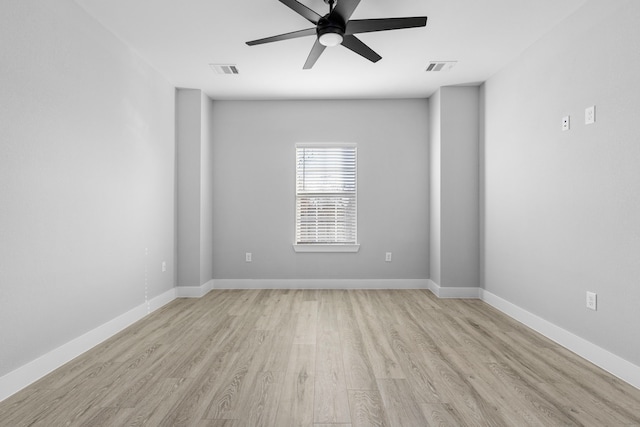 empty room featuring ceiling fan and light hardwood / wood-style flooring