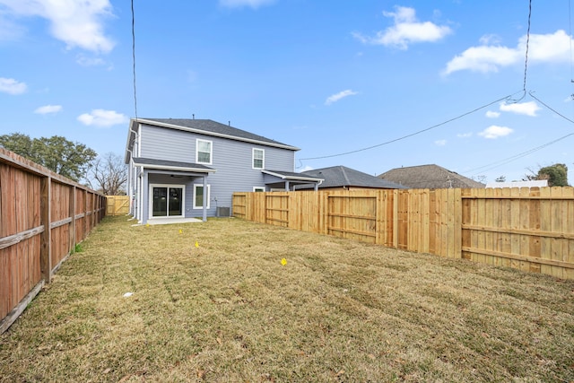 rear view of house featuring a yard