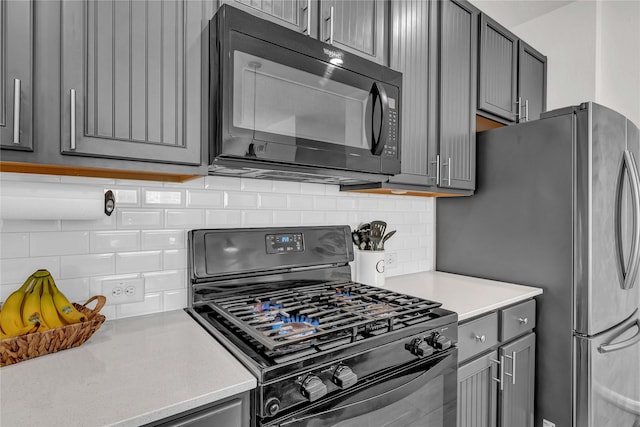 kitchen with decorative backsplash, gray cabinets, and black appliances