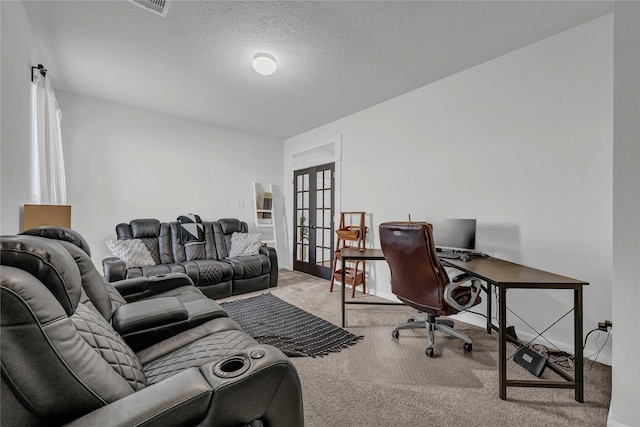 carpeted office with french doors and a textured ceiling