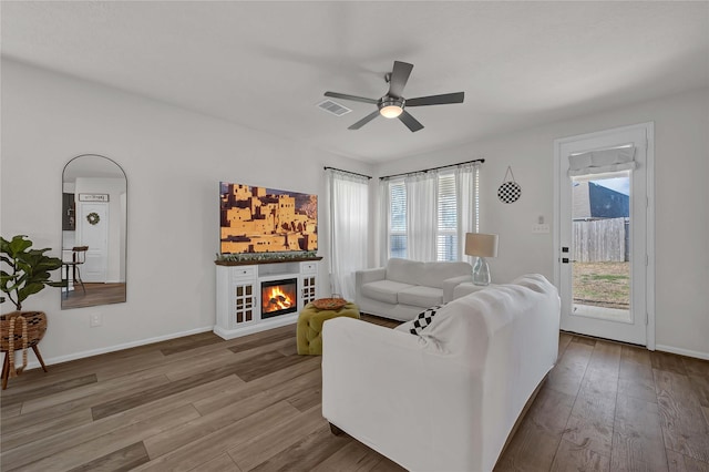 living room featuring hardwood / wood-style flooring and ceiling fan