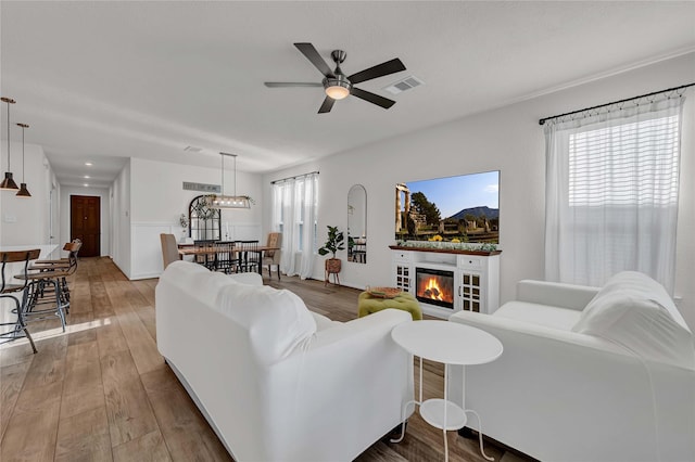 living room with wood-type flooring and ceiling fan