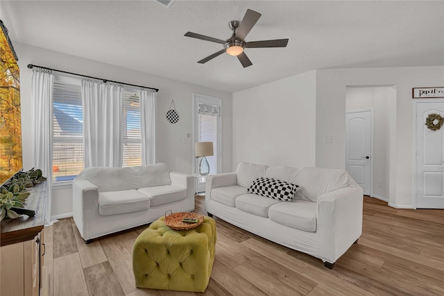 living room with ceiling fan and light wood-type flooring