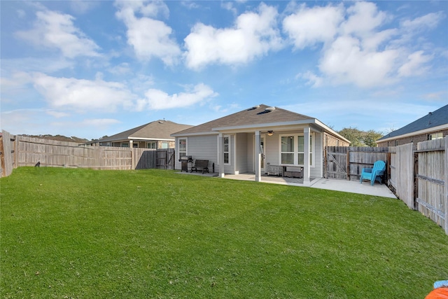 back of house featuring ceiling fan, a yard, and a patio area