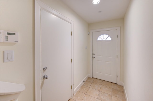 doorway to outside with light tile patterned floors and sink