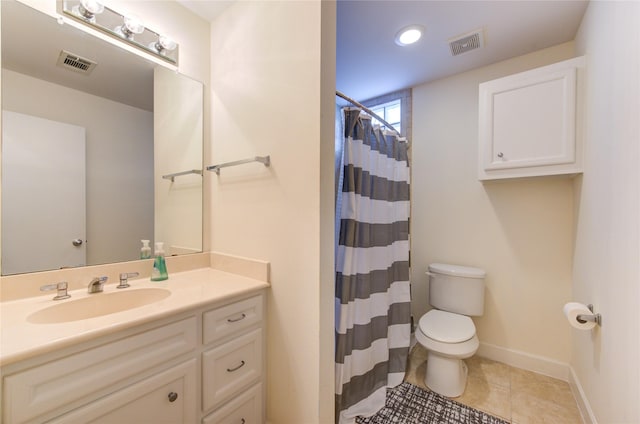 bathroom with vanity, walk in shower, tile patterned floors, and toilet