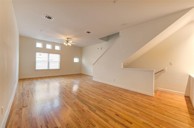 unfurnished living room with ceiling fan and light hardwood / wood-style flooring