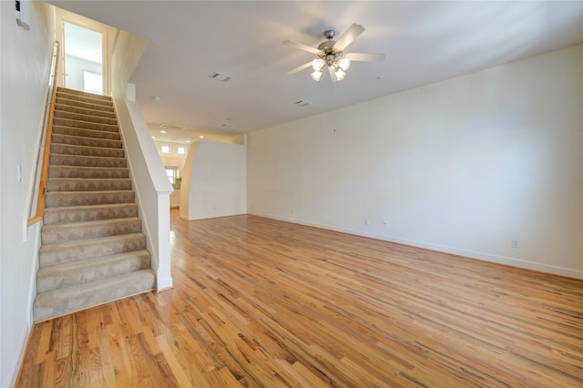 unfurnished living room featuring light hardwood / wood-style flooring and ceiling fan