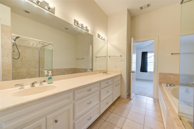 bathroom with independent shower and bath, vanity, and tile patterned floors