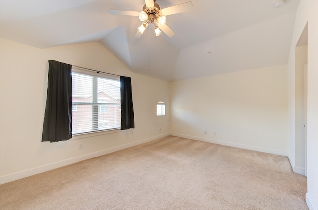 unfurnished room featuring vaulted ceiling, light carpet, and ceiling fan