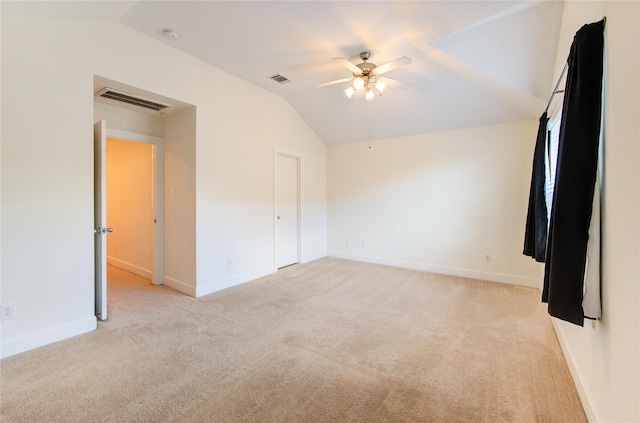 unfurnished bedroom with lofted ceiling, light colored carpet, and ceiling fan