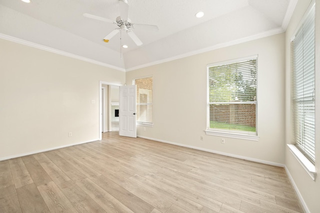 spare room with vaulted ceiling, ornamental molding, ceiling fan, and light wood-type flooring