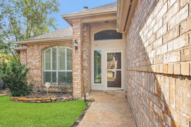 entrance to property with a lawn