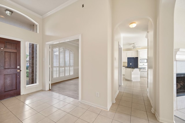 entrance foyer with ornamental molding and light tile patterned floors