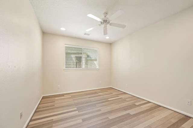 unfurnished room with ceiling fan and light hardwood / wood-style floors