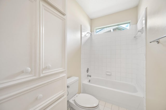 bathroom featuring tiled shower / bath and toilet