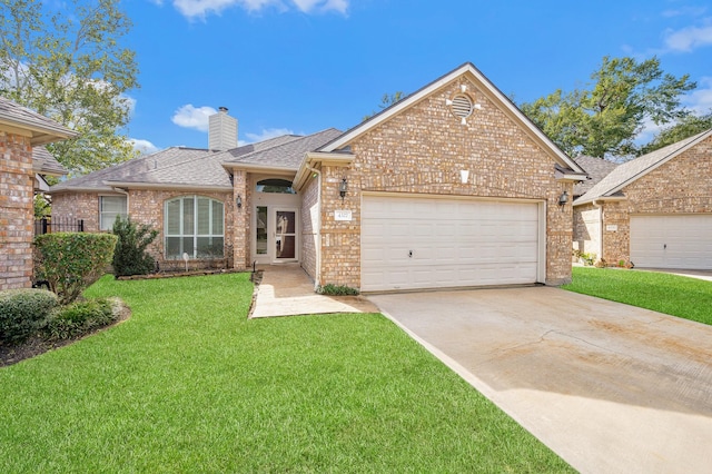 view of front of property featuring a garage and a front yard