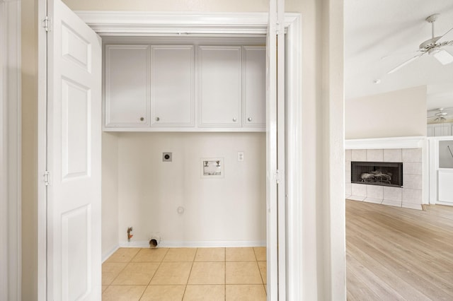 washroom with cabinets, hookup for a washing machine, electric dryer hookup, ceiling fan, and hookup for a gas dryer