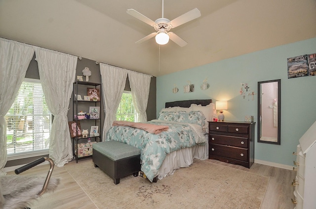 bedroom with vaulted ceiling, light hardwood / wood-style floors, and ceiling fan