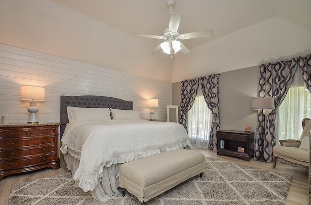 bedroom with lofted ceiling, hardwood / wood-style flooring, and ceiling fan