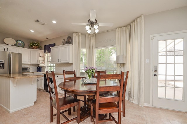 tiled dining area with ceiling fan