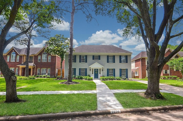 colonial home with a front lawn