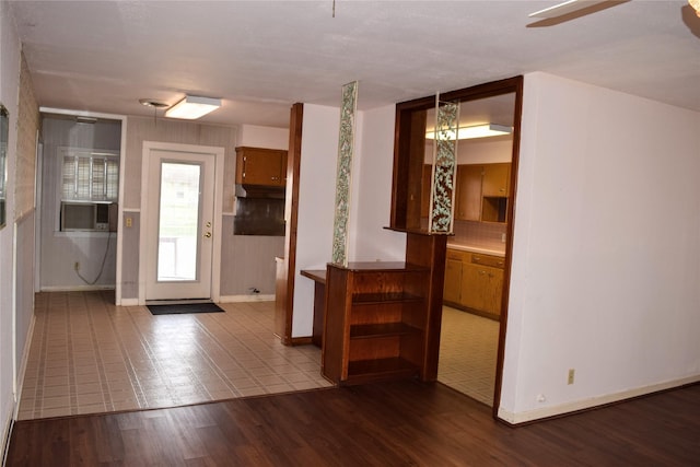 entryway featuring cooling unit, hardwood / wood-style flooring, and ceiling fan