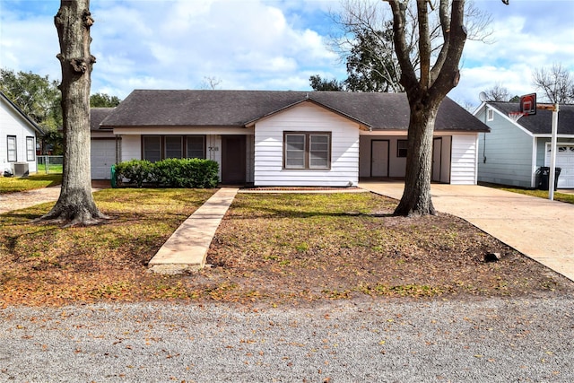 single story home featuring central AC unit, a garage, and a front lawn