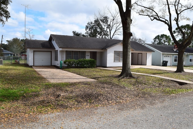 ranch-style house featuring a garage and a front yard