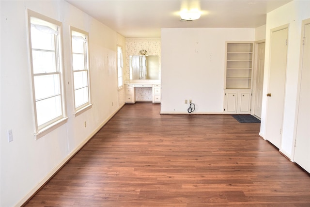 interior space featuring ensuite bath and dark hardwood / wood-style floors