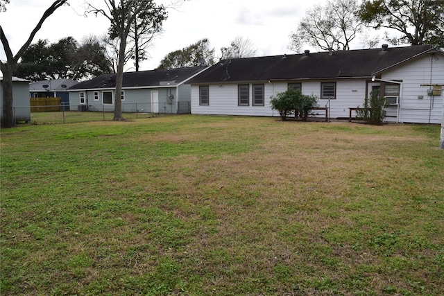 rear view of property with a yard