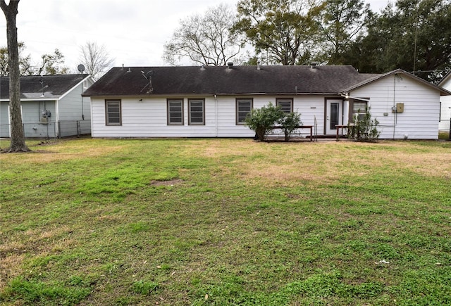 back of property featuring a lawn