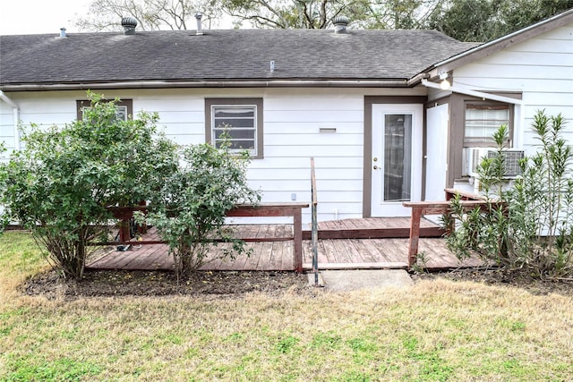 rear view of property with a wooden deck and a yard