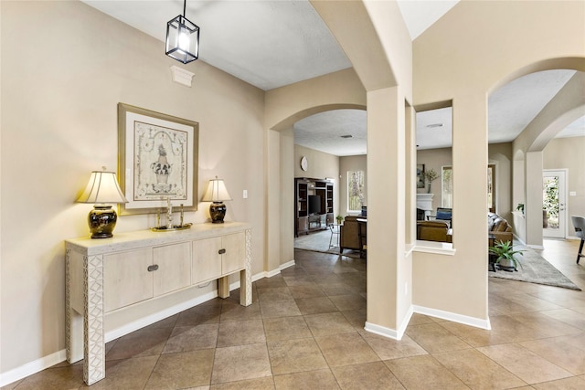 hall with light tile patterned floors