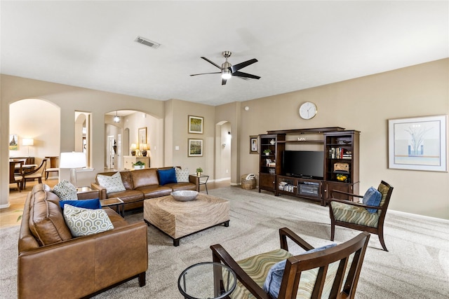 carpeted living room with ceiling fan