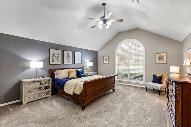 bedroom with vaulted ceiling, carpet, a textured ceiling, and ceiling fan