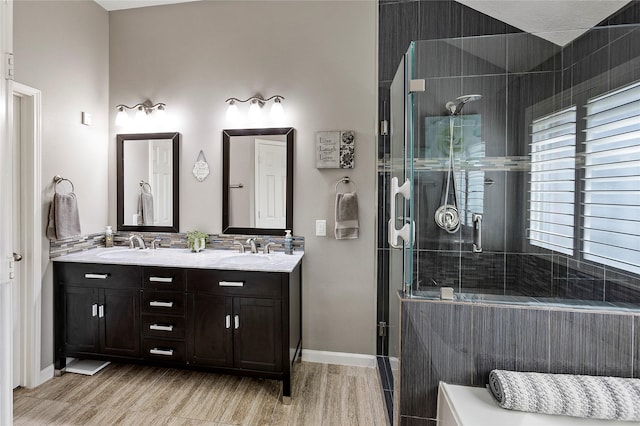 bathroom featuring vanity, an enclosed shower, and hardwood / wood-style floors